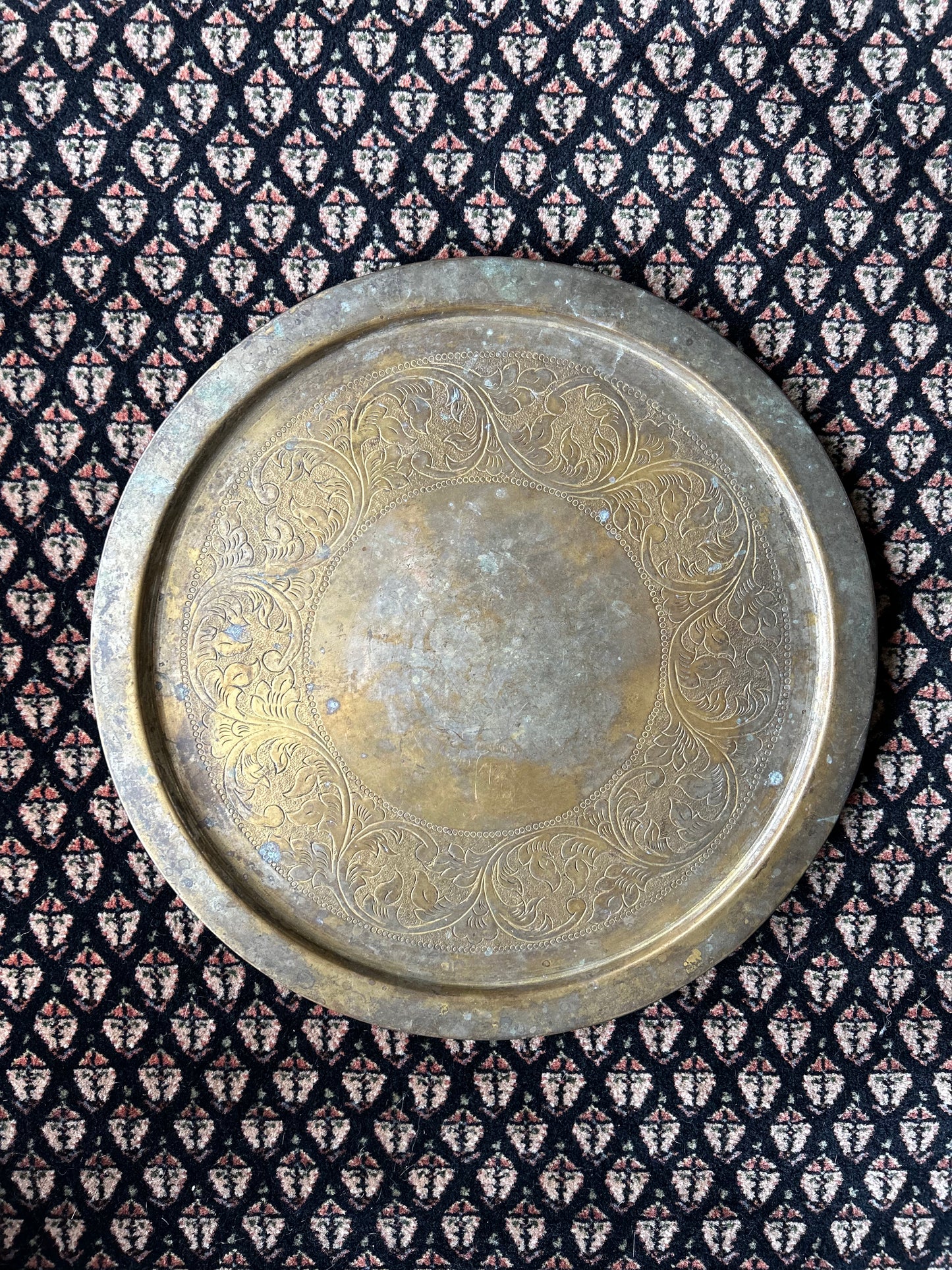 large brass platter with ornate carving